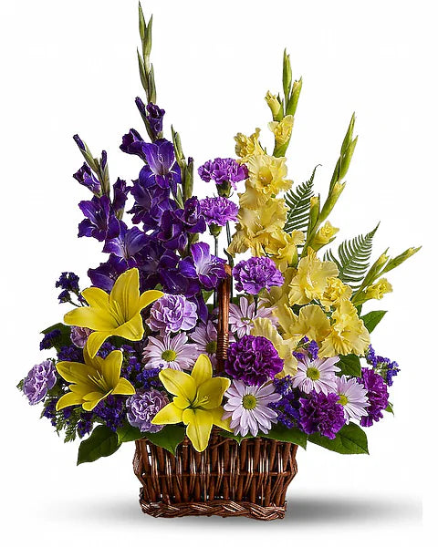 Basket of purple and yellow flowers arranged beautifully against white background