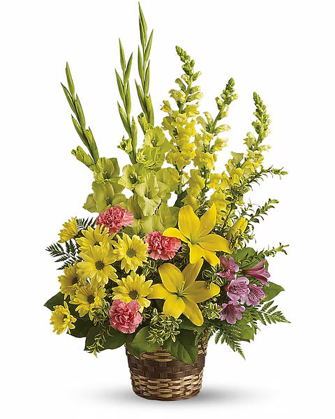Woven basket with yellow and pink flowers arranged elegantly