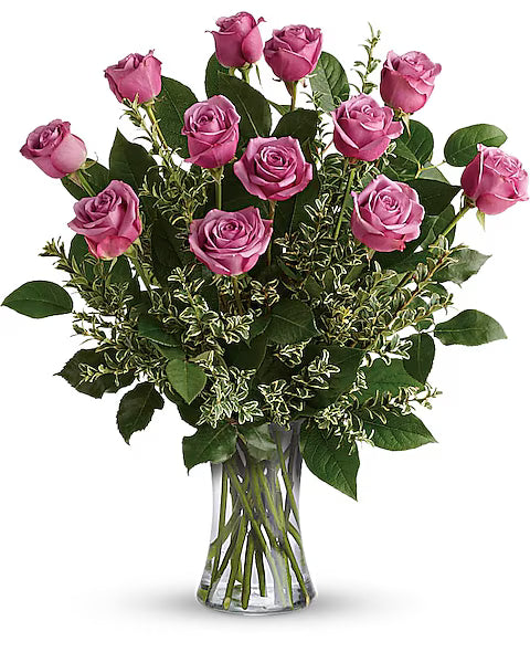 Simple Bouquet of pink roses in a clear vase on a white background