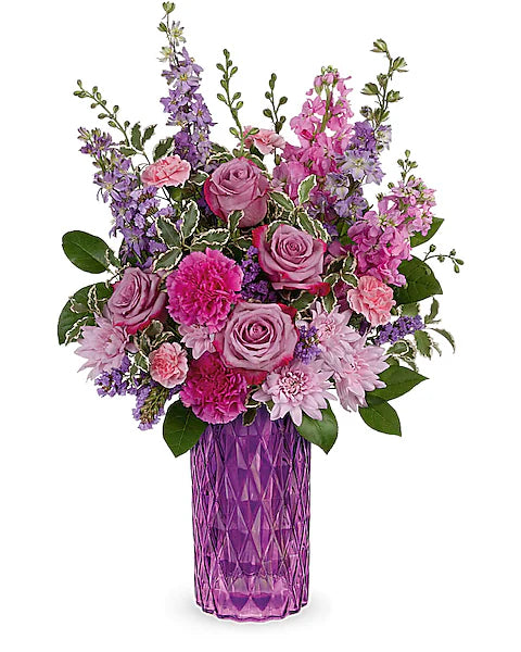 Beautiful pink and purple floral arrangement in violet vase