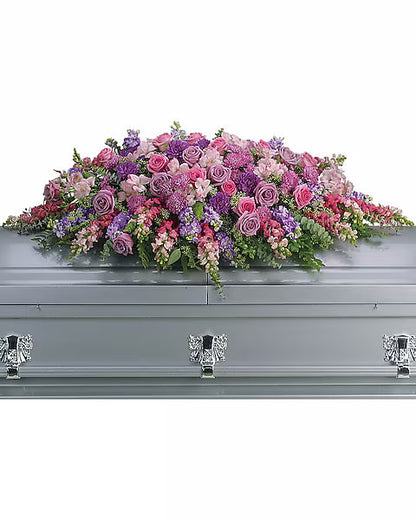 Fresh colorful flowers on gray casket with white background