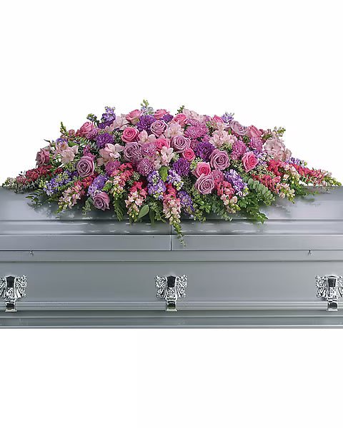 Fresh colorful flowers on gray casket with white background