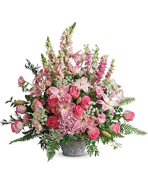 Fresh pink floral bouquet with green leaves on a white background