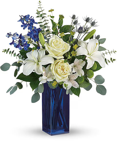 decorative Floral arrangement with white and blue flowers in a blue vase 