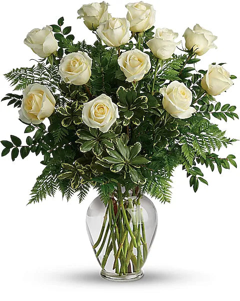 simple Bouquet of white roses in a clear glass vase on a white background